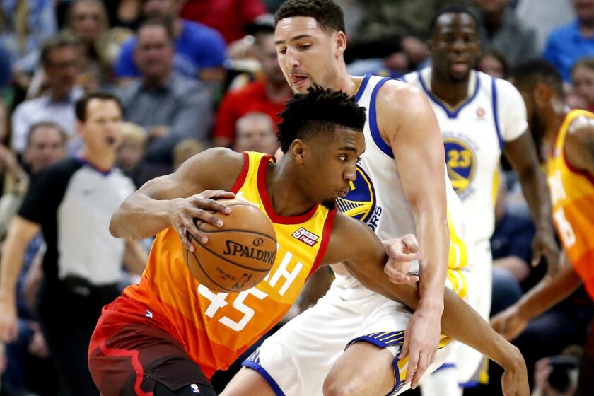 Utah Jazz guard Donovan Mitchell (45) drives around Golden State Warriors guard Klay Thompson, right, in the first half during an NBA basketball game Tuesday, Jan. 30, 2018, in Salt Lake City. (AP Photo/Rick Bowmer)