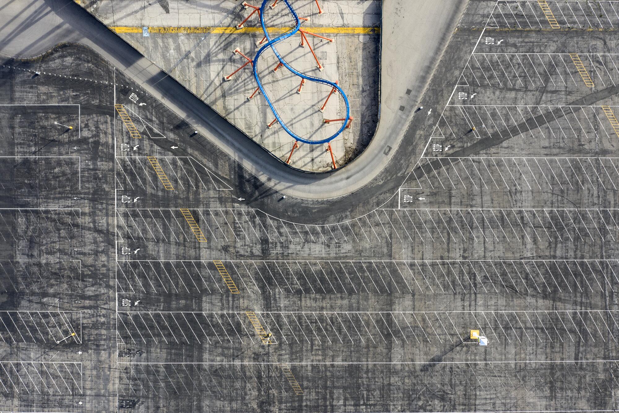 The Scream roller coaster sits dormant next to an empty parking lot.