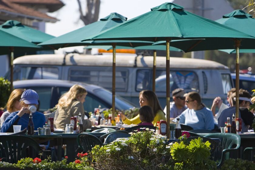 Customers eat breakfast outside during a nice sunny morning at Swami's Cafe, a popular beach restaurant in Encinitas. (Fred Greaves / UT File)