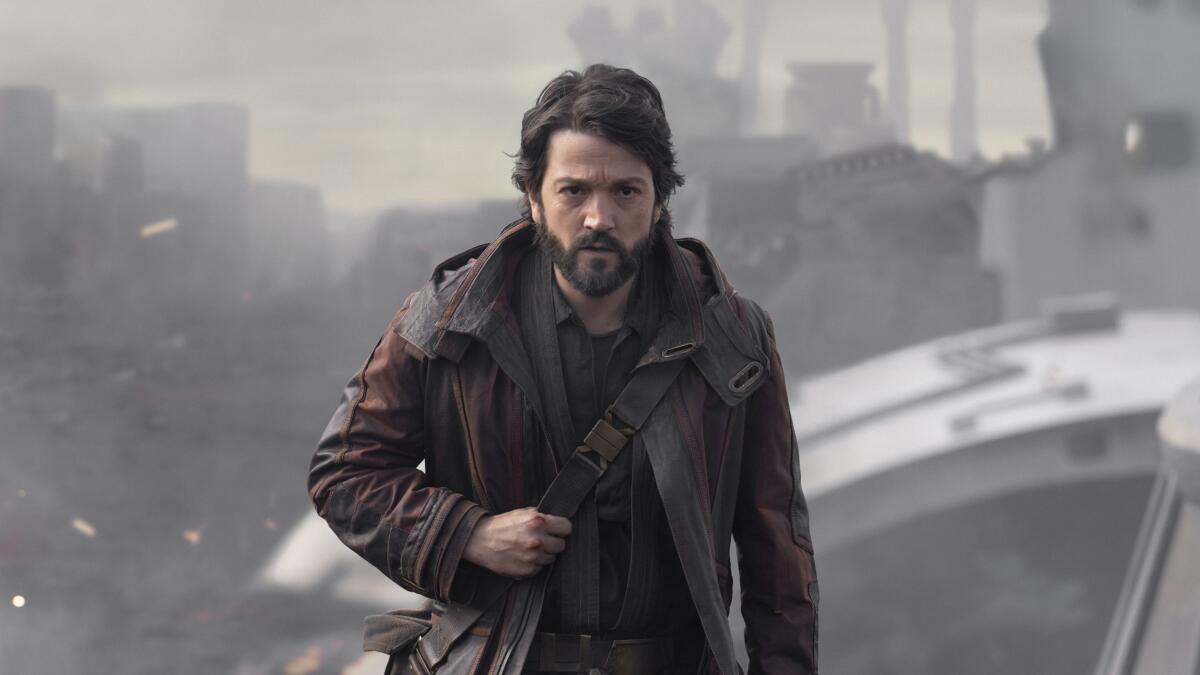 A man in a leather jacket carries a satchel in "Andor."