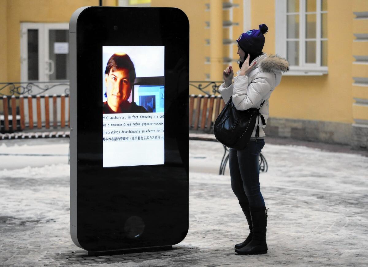 This interactive iPhone statue, seen in 2013, features information about late Apple co-founder Steve Jobs. It has been removed from the campus of a university in St. Petersburg, Russia, after Apple CEO Tim Cook wrote that he is gay.