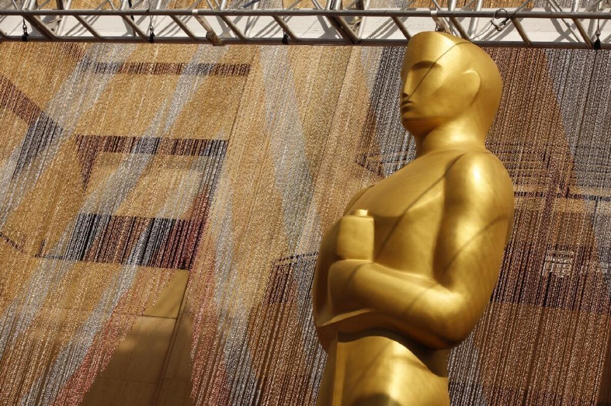 A colorful chain curtain is the backdrop for a giant Oscar statue at Hollywood and Highland for the ceremony on Feb. 26.