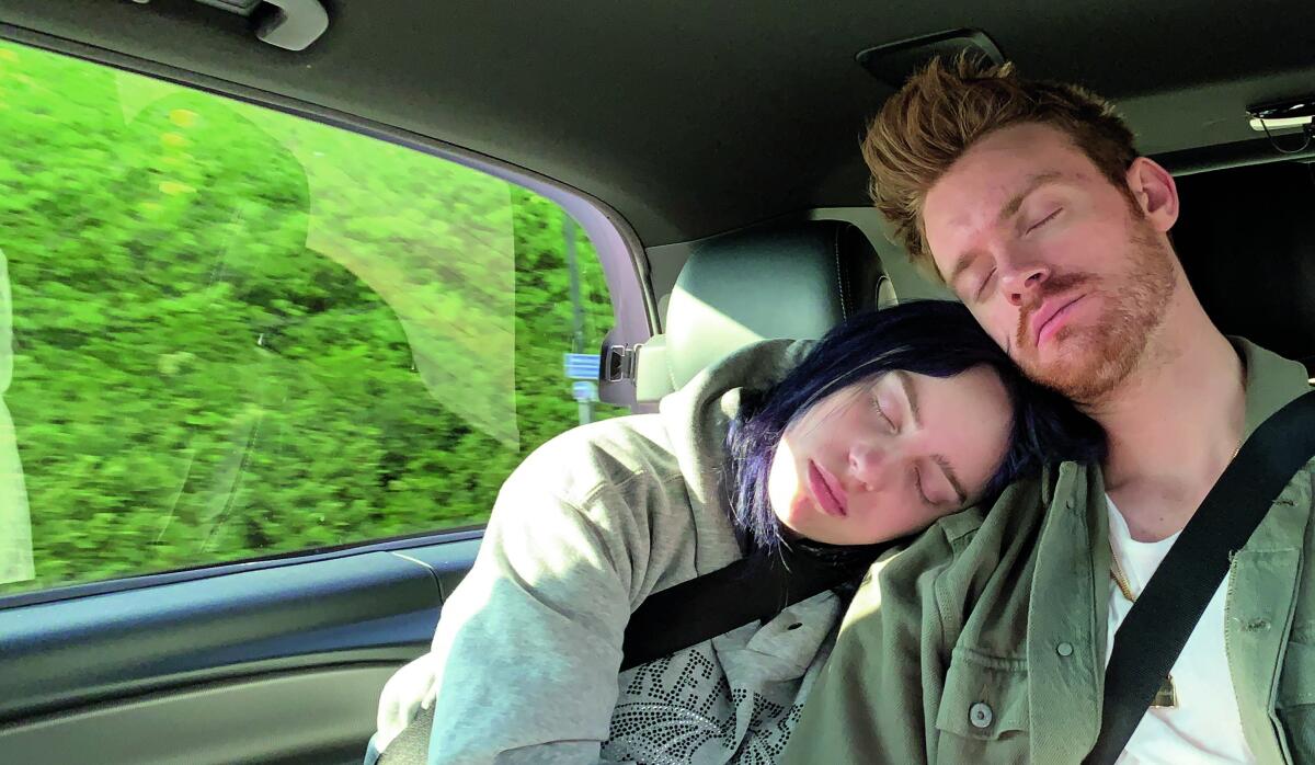 A woman and man asleep in a car