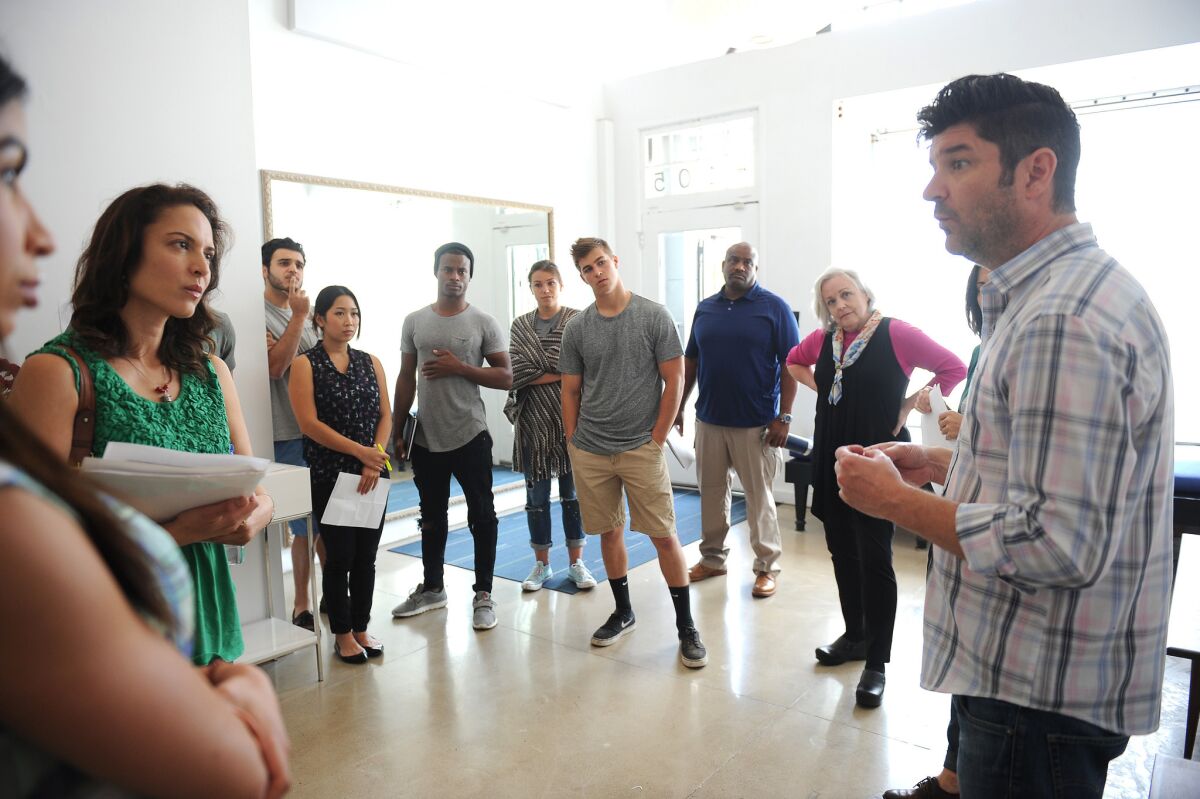 Killian McHugh, right, speaks to students in one of his acting workshops.