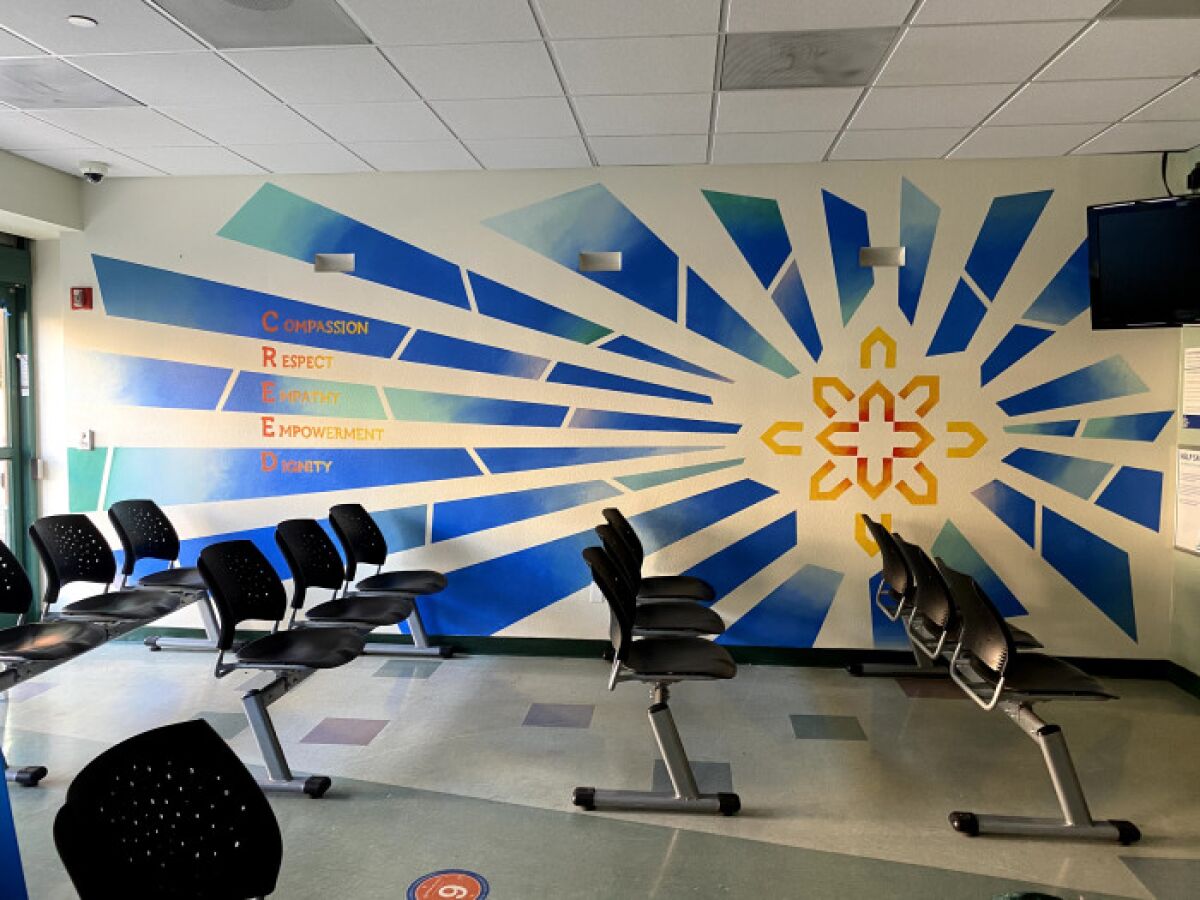 Diane Lehman's mural in the Father Joe's Villages clinic waiting room features the organization's colors, logo and CREED.