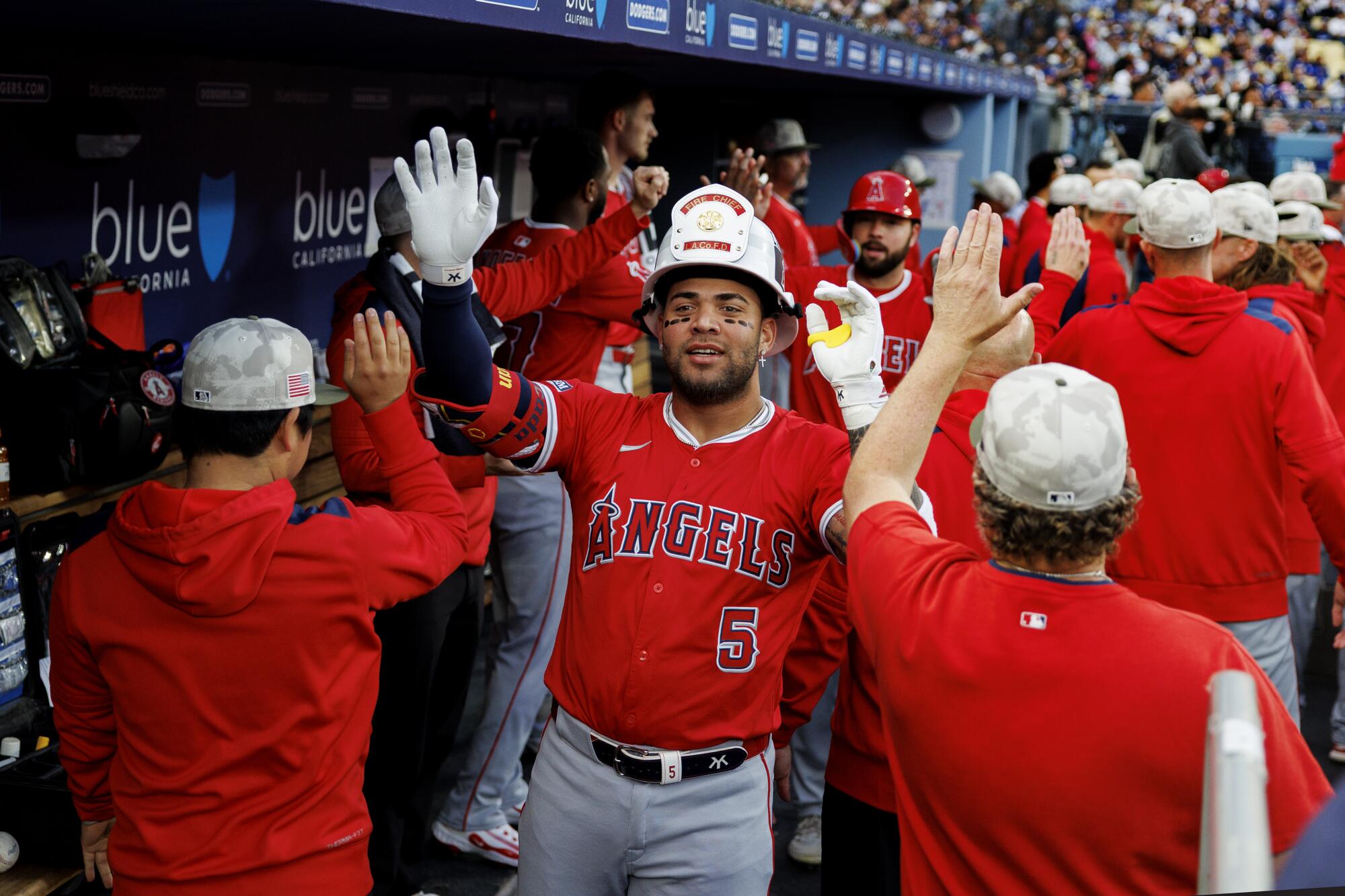 Angels third base Yoan Moncada celebrates in the dugout after hitting a two-run home run at Dodger Stadium.