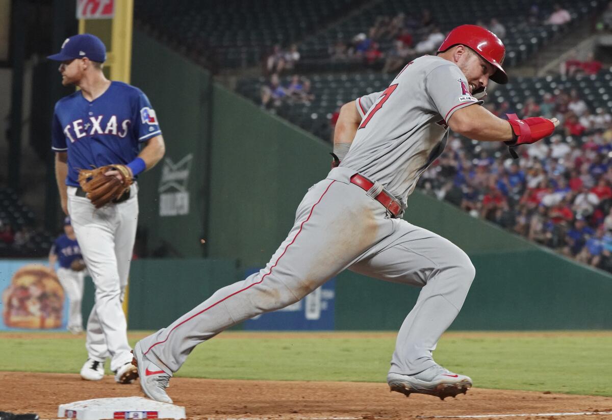 Angels' Mike Trout rounds third base as he heads home to score during the sixth inning against the Texas Rangers on Wednesday in Arlington, Texas.