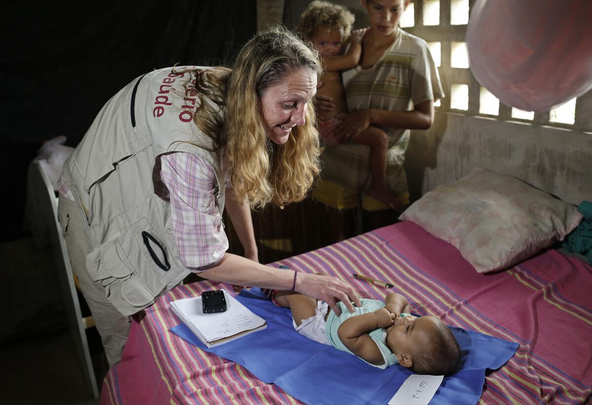 Pediatrician Alexia Harrist from the U.S. Centers for Disease Control and Prevention examines Angeline Karolayne in Joao Pessoa, Brazil. U.S. and Brazilian health workers knocked on doors in one of Brazil's poorest neighborhoods in a bid to enroll mothers in a study of Zika's possible role in causing birth defects.