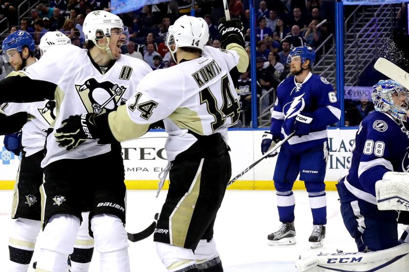 Penguins left wing Chris Kunitz (14) celebrate with center Evgeni Malkin after scoring a goal against the Lightning in the third period of Game 3 on Wednesday night.