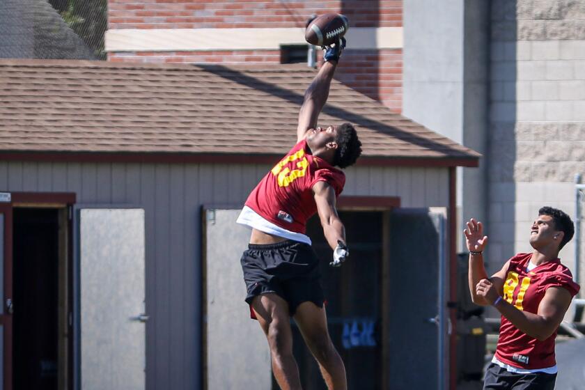 USC freshman Munir McClain leaps up for a pass on the sideline Monday.