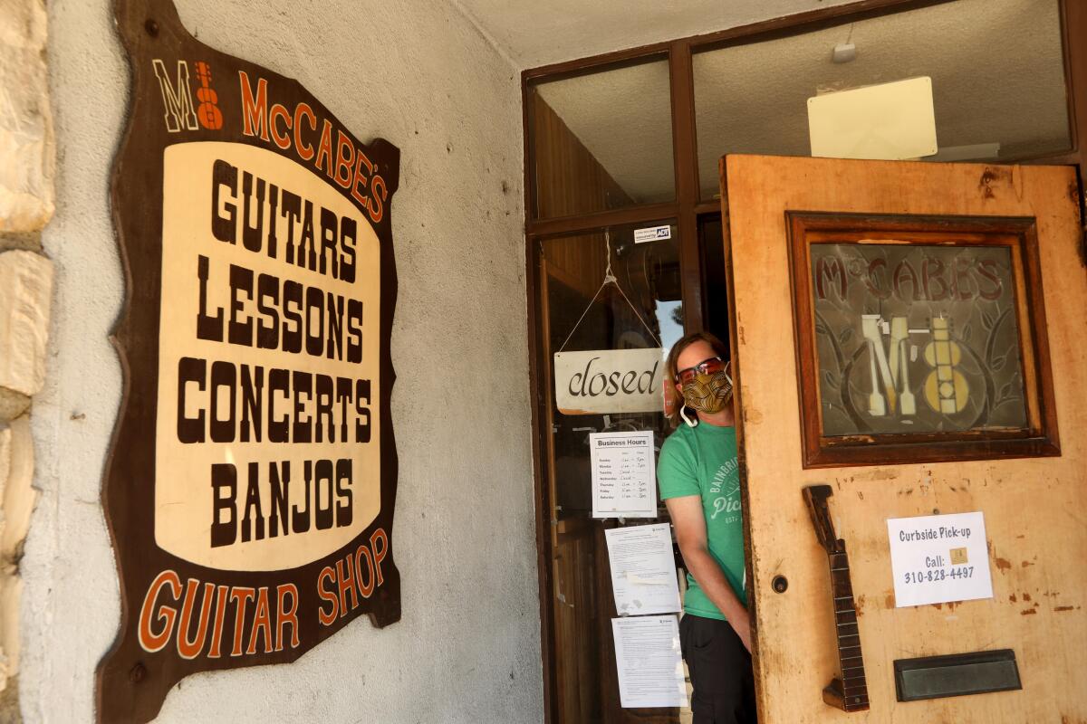 Walt McGraw looks out from the front door of McCabe's Guitar Shop 