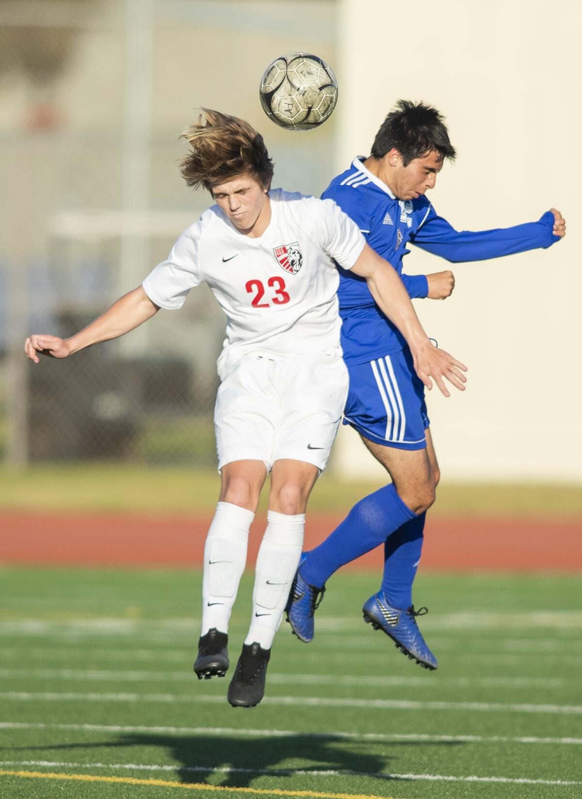 Fountain Valley's Chris Ouellette, right, goes up for a header against Mater Dei's Tae Ulicny in the first round of the CIF Southern Section Division 1 playoffs on Wednesday.