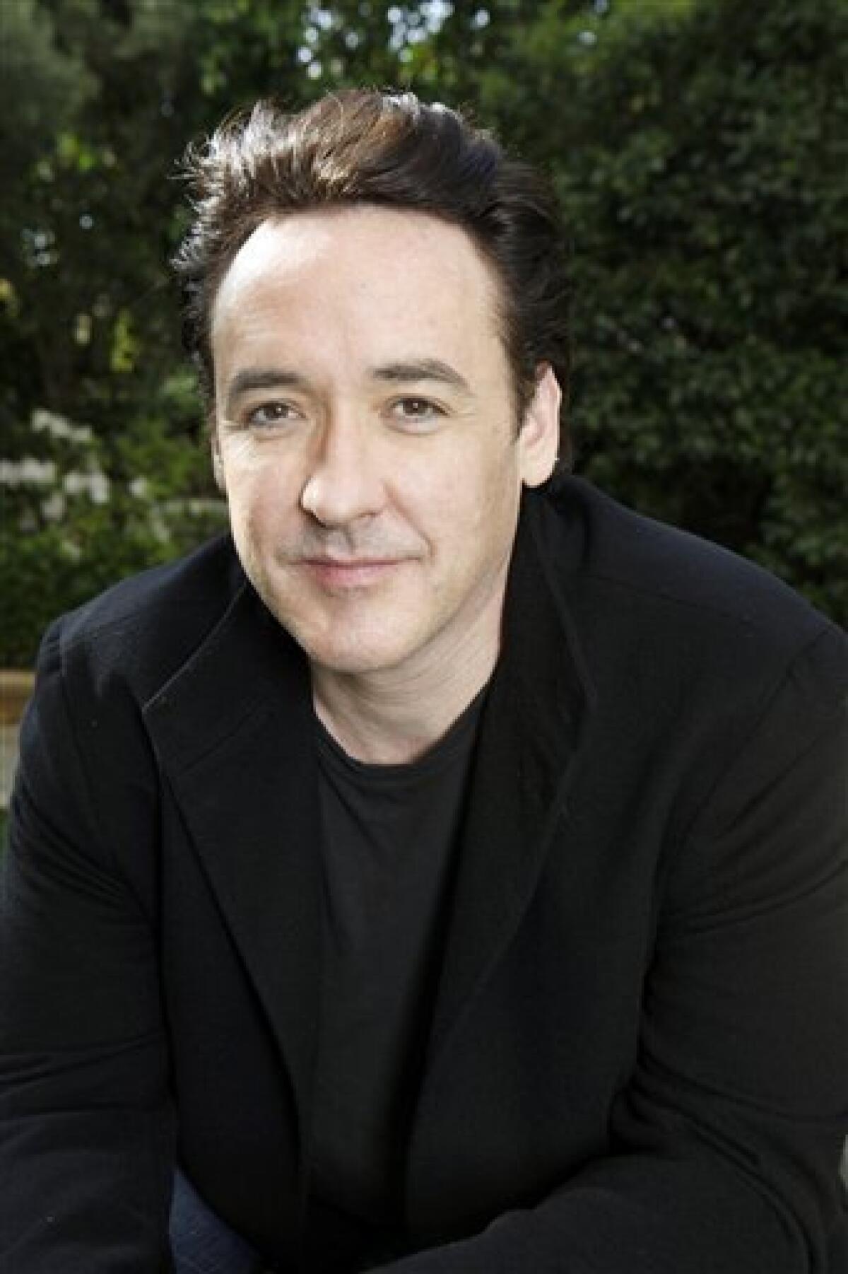 In this March 20, 2010 photo, actor John Cusack poses for a portrait in Los Angeles. (AP Photo/Reed Saxon)