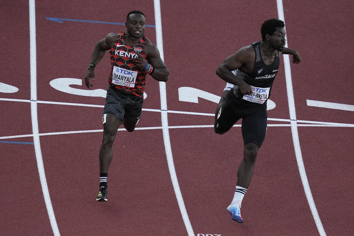 Ferdinand Omanyala, left, of Kenya, runs in a heat of the men's 100-meter 