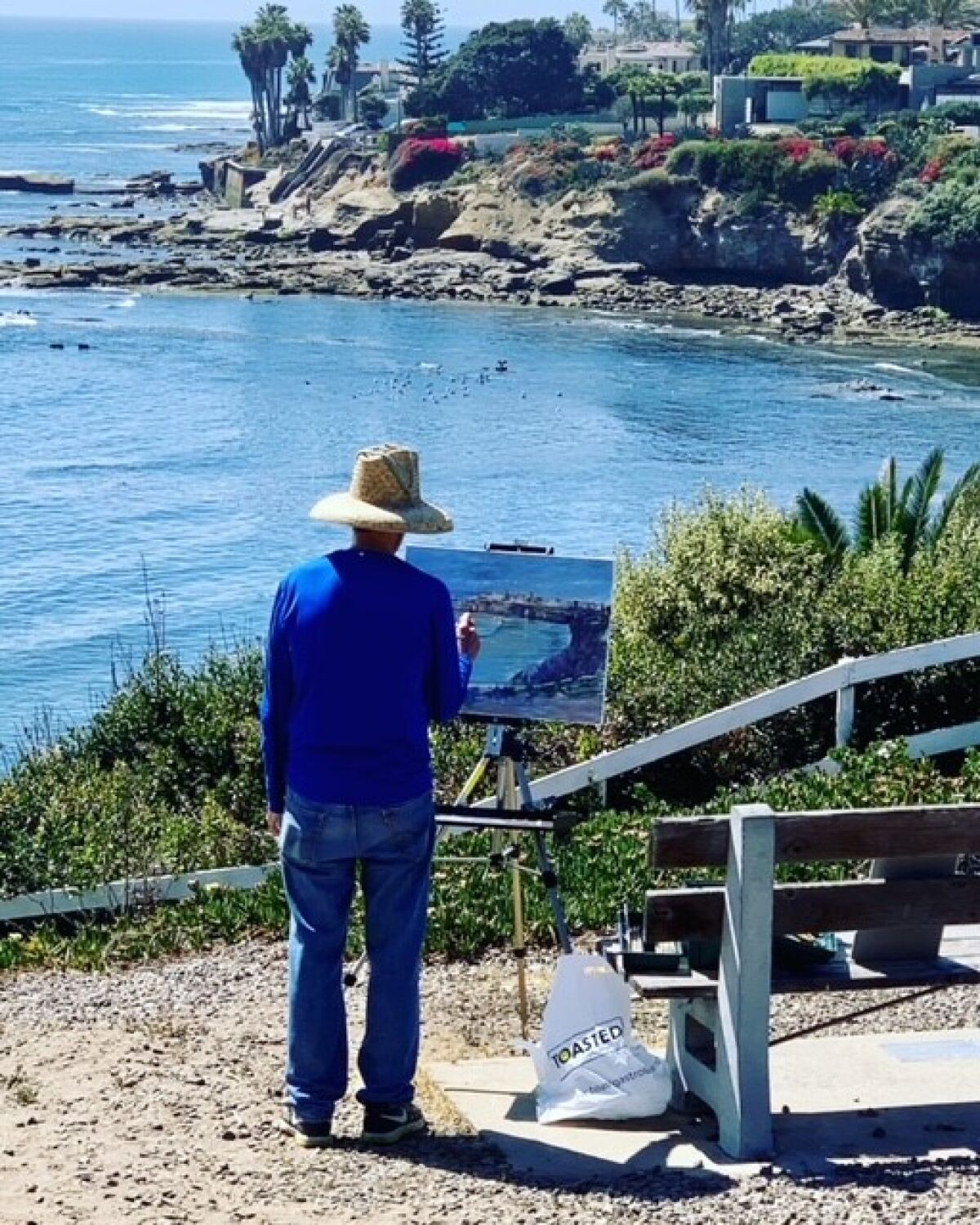 An artist paints a view from La Jolla Hermosa Park.