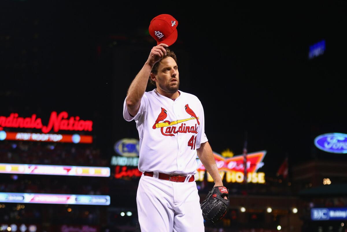 St. Louis Cardinals' John Lackey tips his hat to fans as he walks off the field in the eighth inning against the Chicago Cubs during Game One of the National League Division Series on Friday.
