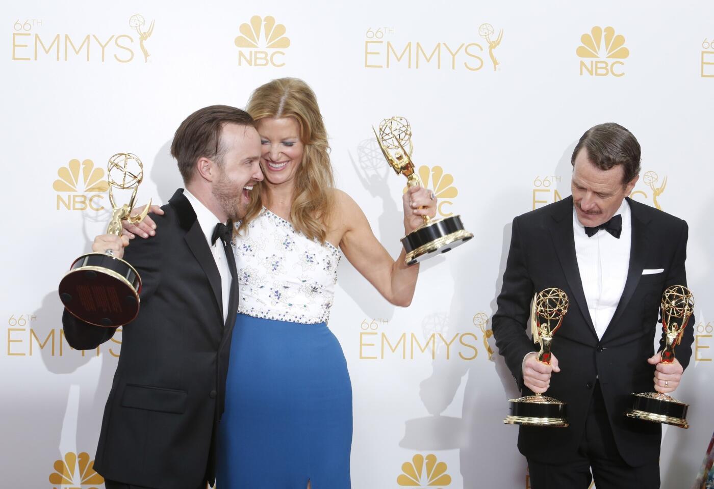 "Breaking Bad" cast members, from left, Aaron Paul, Anna Gunn and Bryan Cranston clutch their Emmys for drama series.