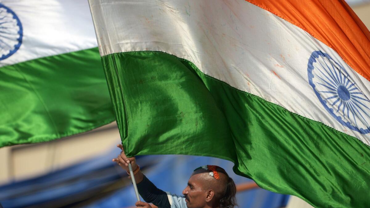 An Indian cricket supporter waves the Indian flag at a rally in Kolkata on March 18, 2016.