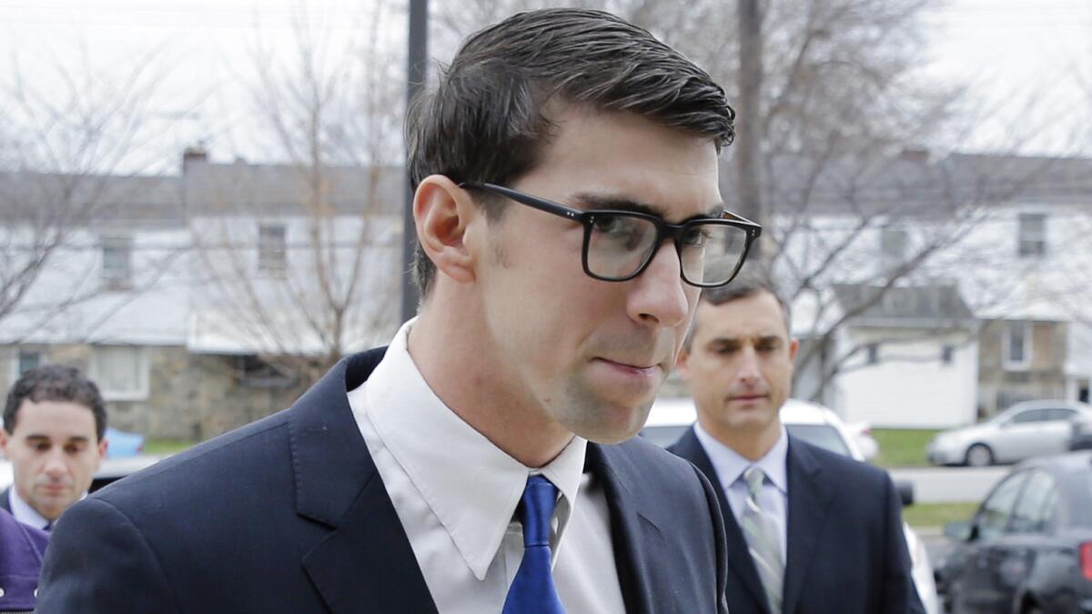 Olympic swimmer Michael Phelps walks into a Baltimore courthouse before pleading guilty to a drunken driving charge on Friday.