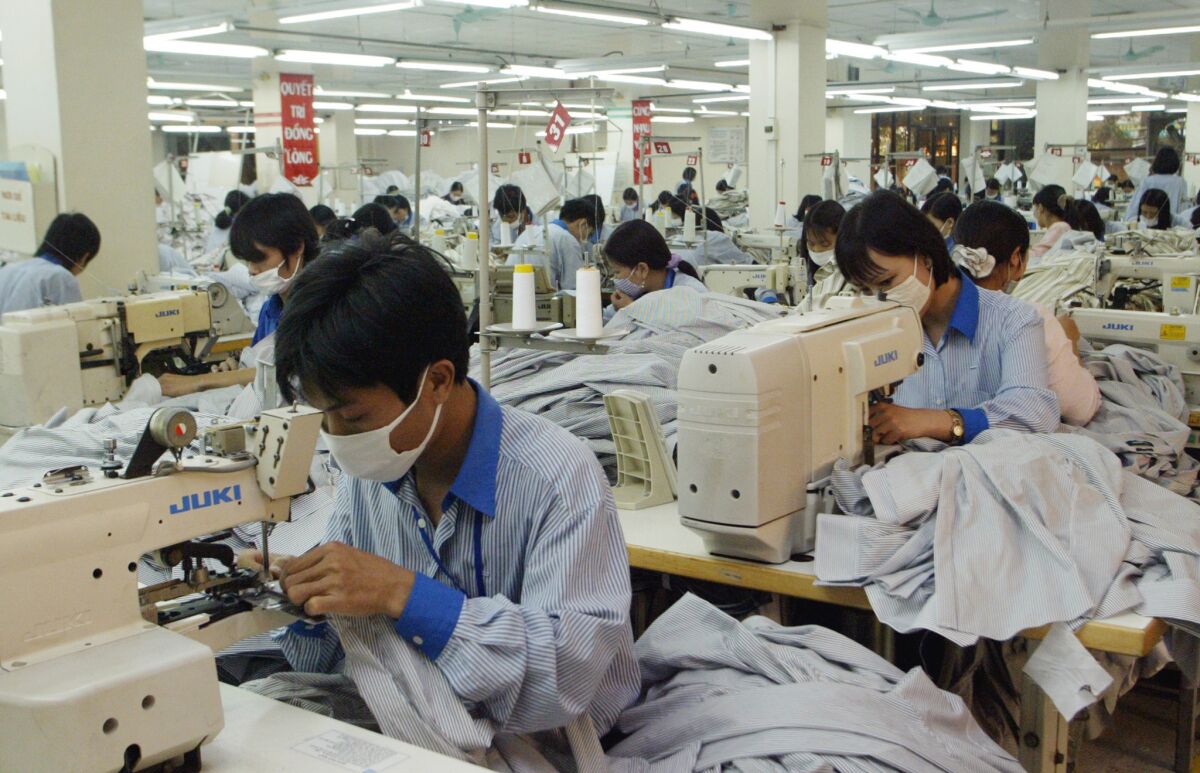 Workers sew shirts to be exported to the United States at Garment Company 10 outside Hanoi, Vietnam in 2007.
