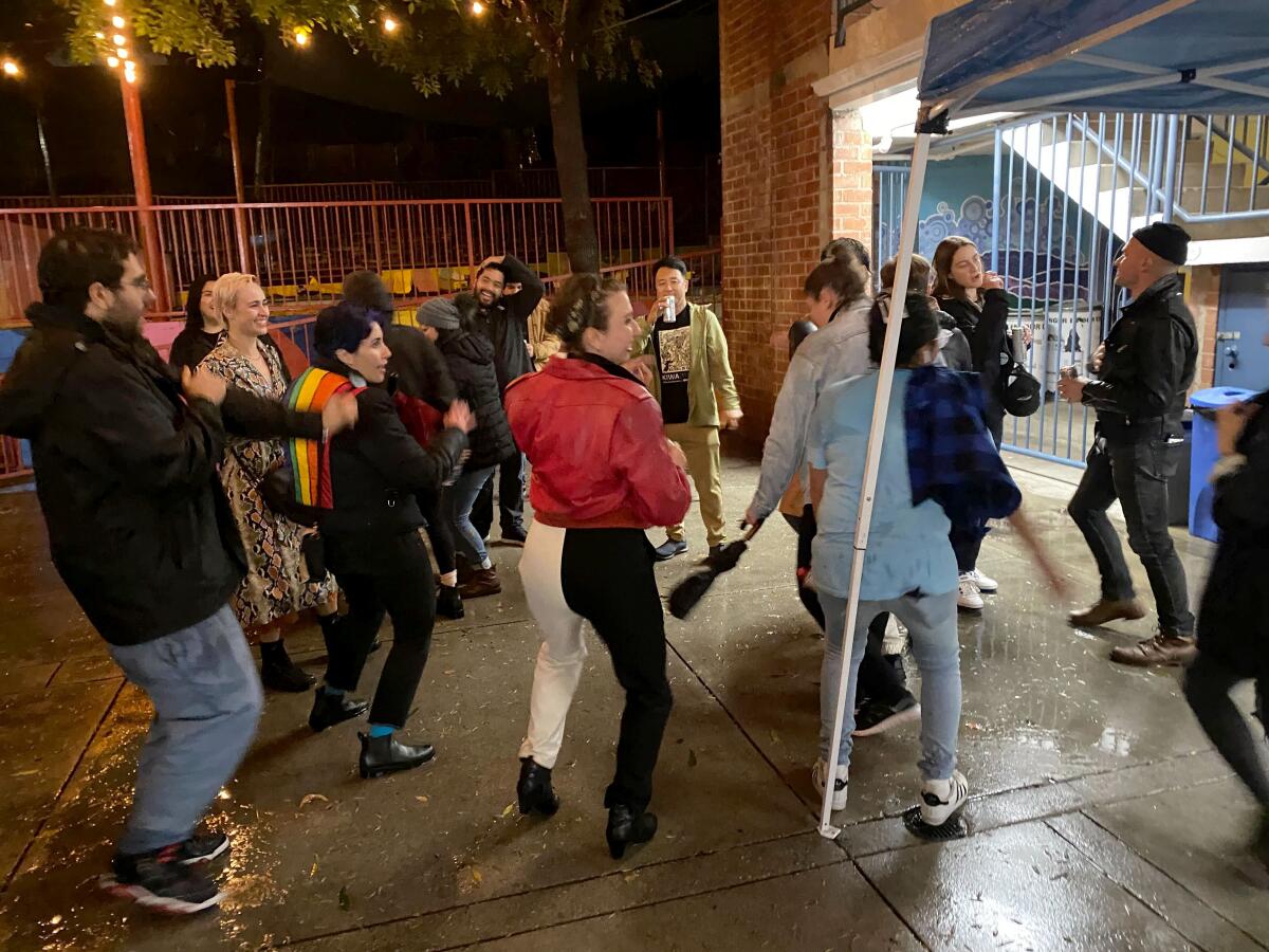 Democratic socialists dance in the rain on election night party in L.A.