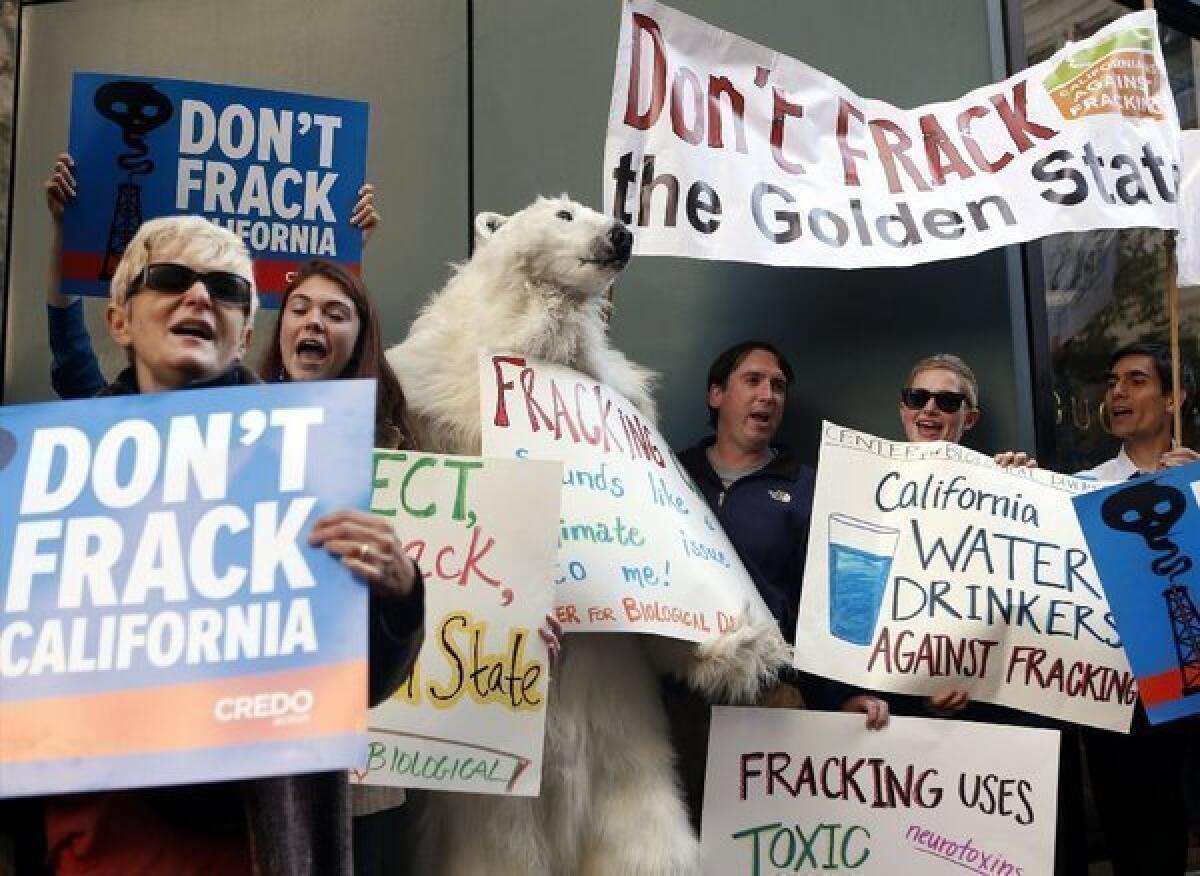 Environmental demonstrators in September protest Gov. Jerry Brown's position on natural gas fracking before Brown arrived for a news conference in San Francisco. The governor has released draft regulations on fracking that are based on a bill passed earlier this year by the state Legislature.