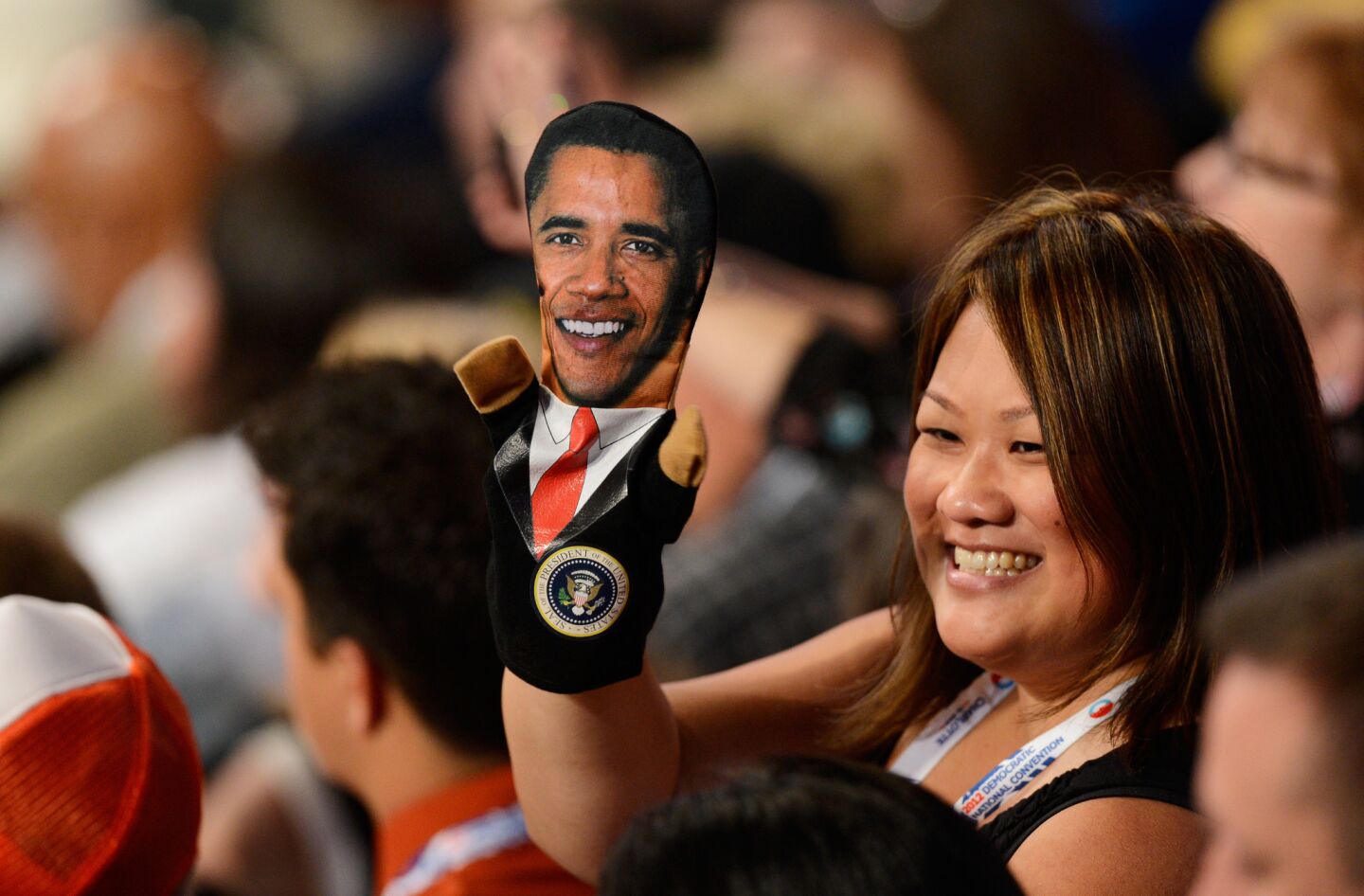 Kaying Thao from Minnesota wears a puppet of President Obama during day two of the Democratic National Convention Charlotte, N.C.