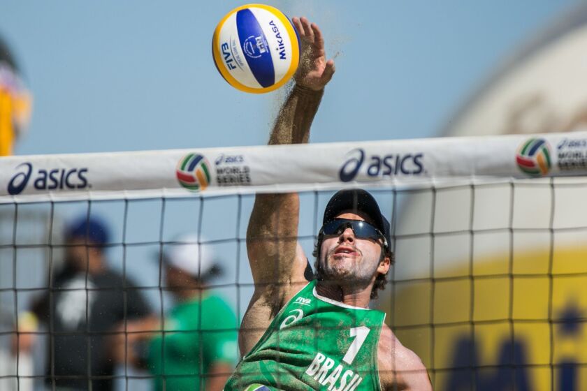 LONG BEACH, CALIF. -- SUNDAY, AUGUST 23, 2015: Bruno Schmidt spikes the ball back towards the USA court during their match at the ASICS beach volleyball tournament in Long Beach, Calif., on Aug. 23, 2015. (Marcus Yam / Los Angeles Times)