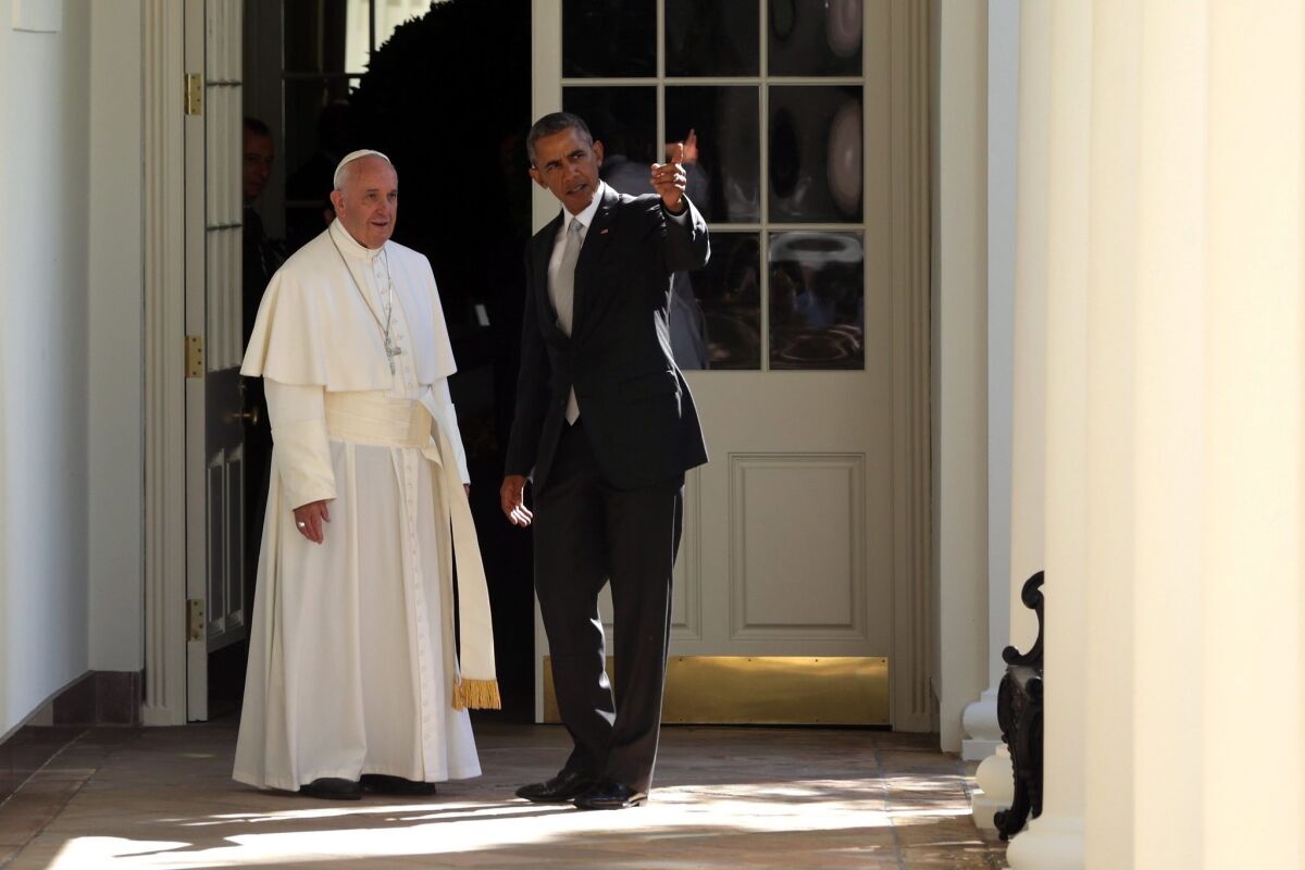 President Obama escorts Pope Francis down the West Wing colonnade walk during the arrival ceremony at the White House. ALEX WONG / POOL / EPA