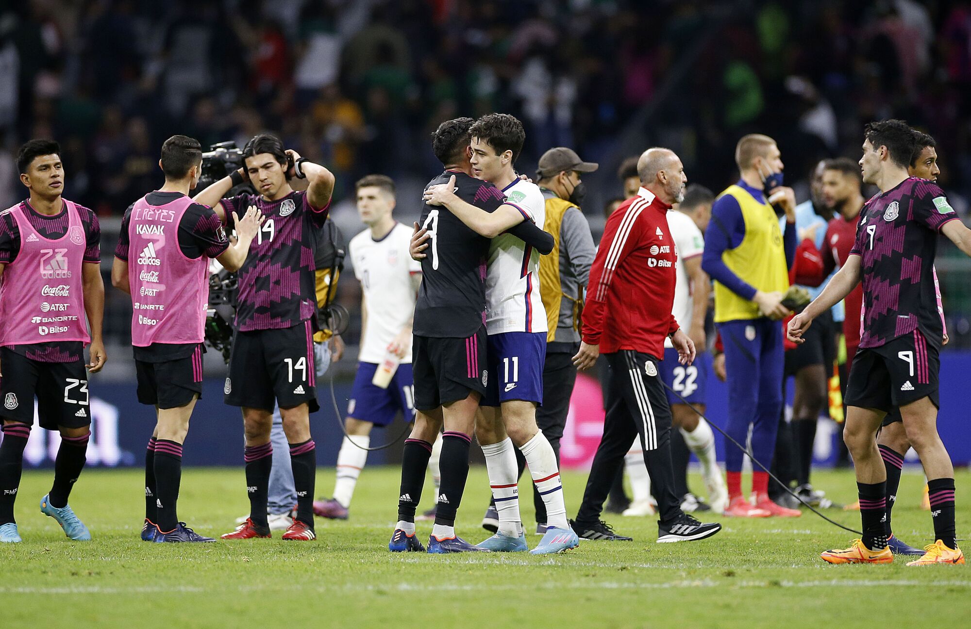 U.S. midfielder Gio Reyna, right, and Mexico midfielder Edson Alvarez congratulate each other.