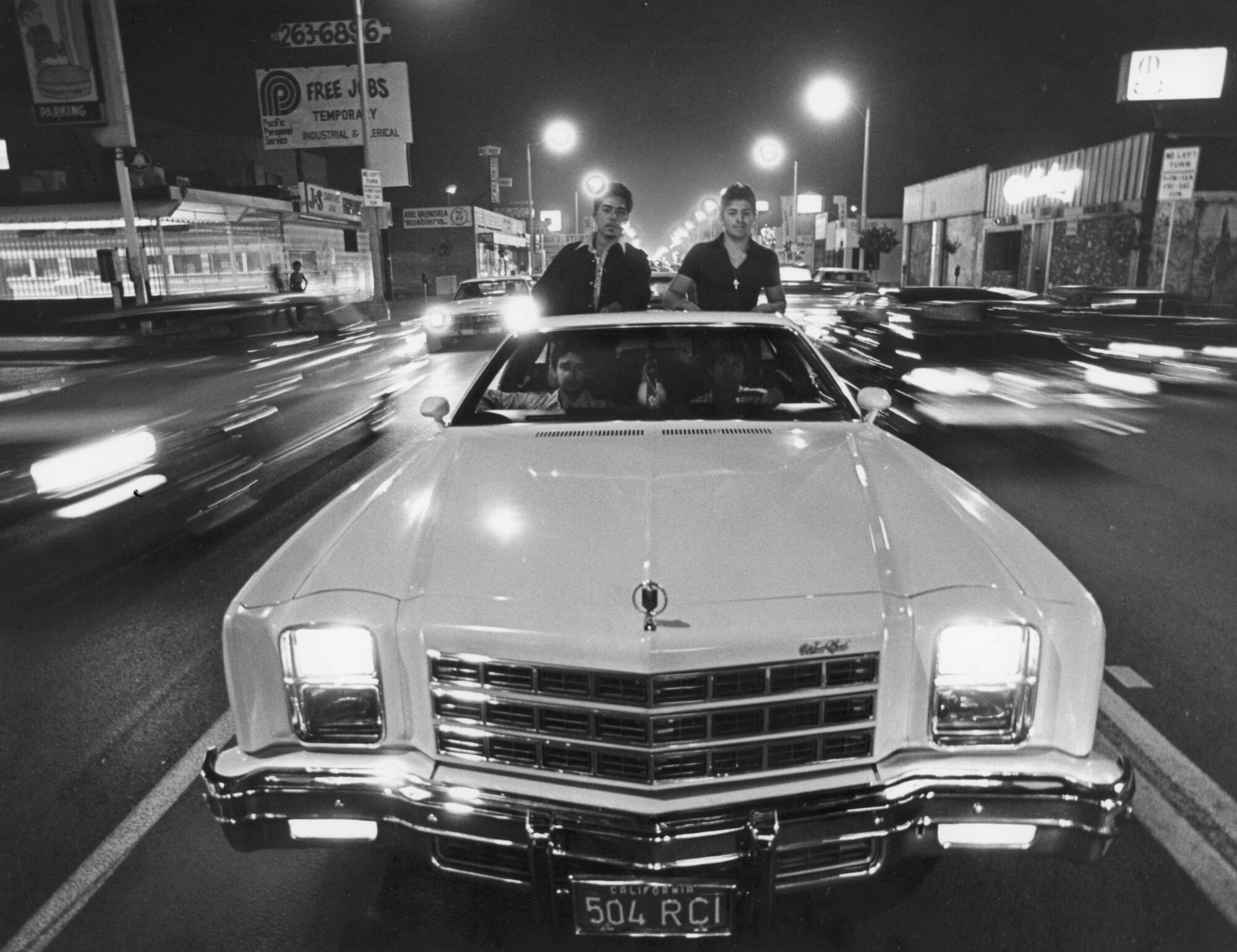 A group of men drive down Whittier Boulevard in 1979.
