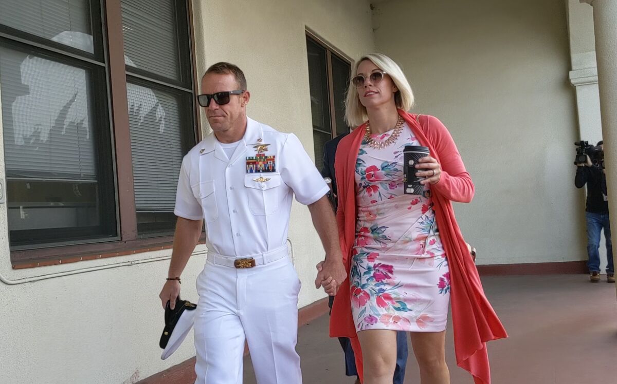 Navy SEAL Chief Edward R. Gallagher and his wife Andrea Gallagher at the Naval Base San Diego courthouse in July for closing arguments and jury deliberation in Chief Gallagher's war crimes murder trial. He was acquitted on most counts but convicted of posing in a photo with a corpse.