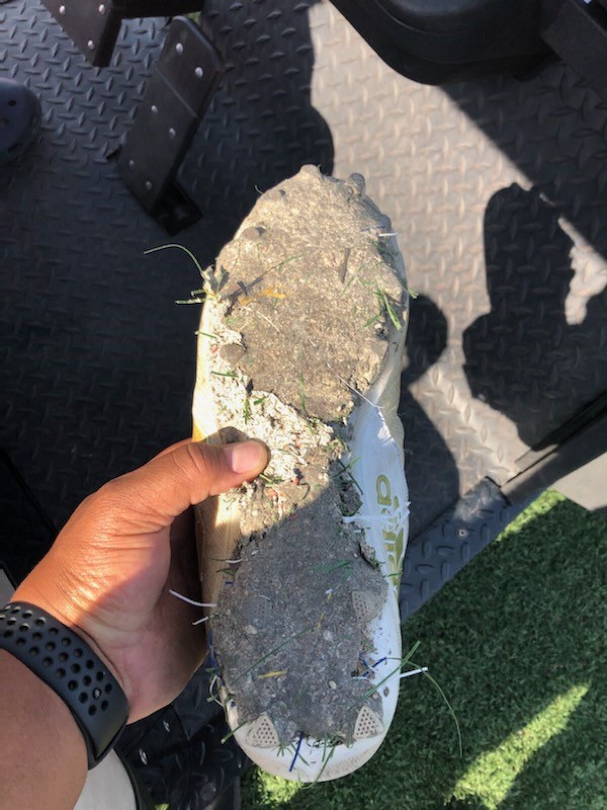 A cleat is covered with the strange substance from Crenshaw High's all-weather turf field.