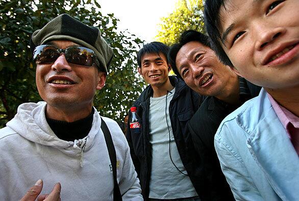 Qi Shuyo, far left, and others wait at the gates of the Beijing Film Studio, hoping to be called for an audition.