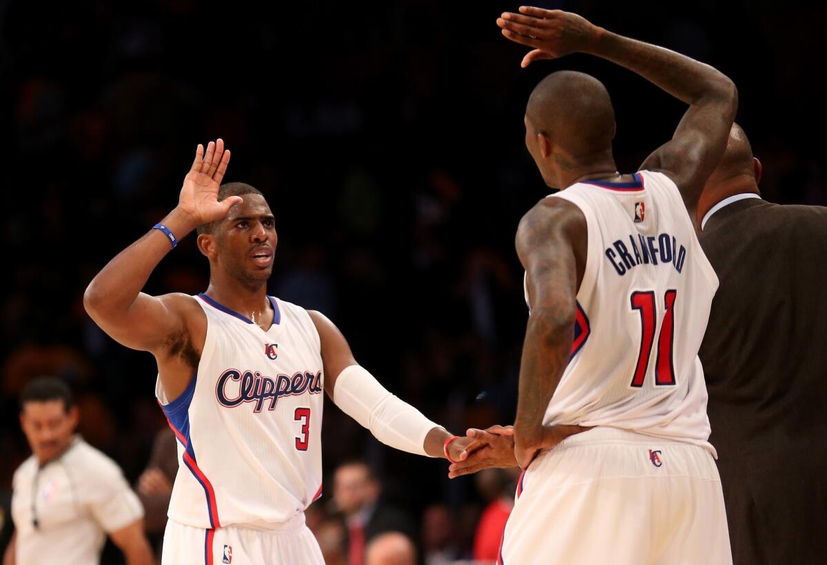 Chris Paul and Jamal Crawford celebrate in the final minute of the Clippers' 118-111 win over the Lakers on Oct. 31.