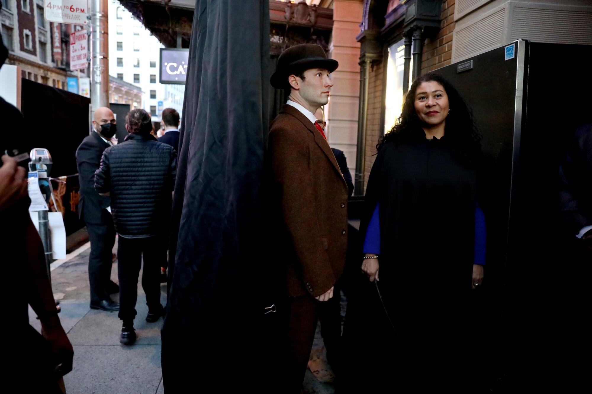 London Breed, right, mayor of San Francisco, shown with a cast member behind a curtain