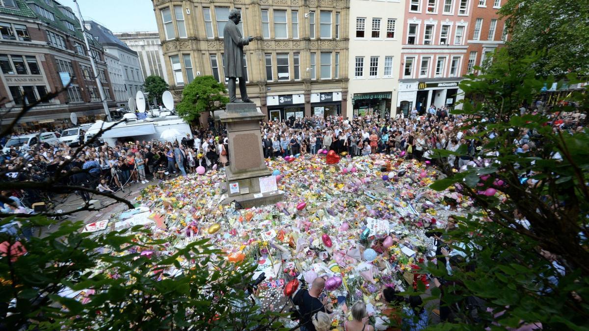 A minute of silence is held in a square in central Manchester, England, on May 25.