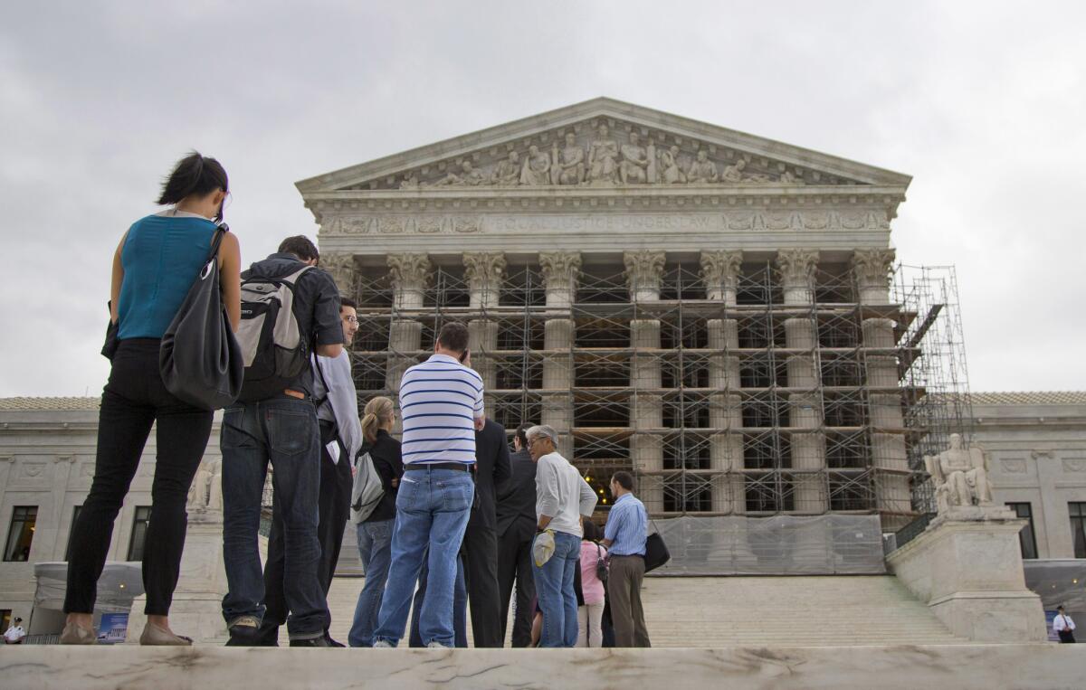 People wait in line to enter the Supreme Court in Washington.