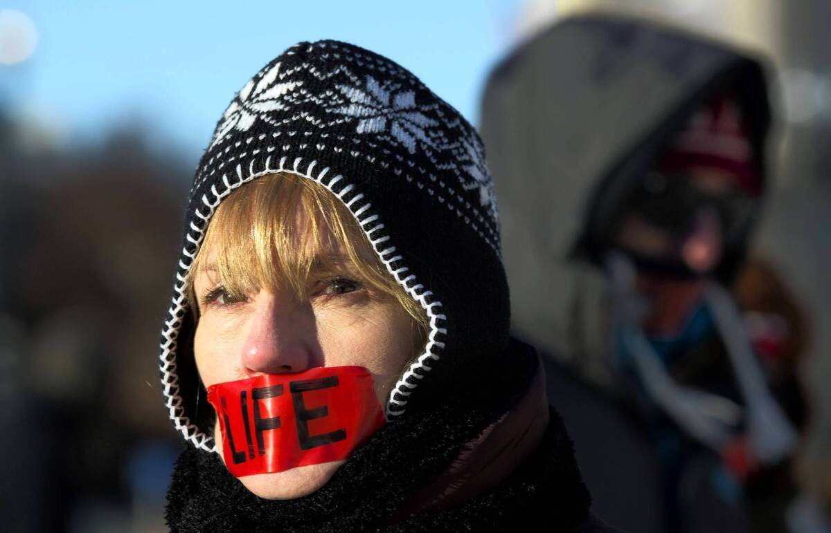 An anti-abortion activist protests Tuesday at the Supreme Court on the 40th anniversary of Roe vs. Wade.