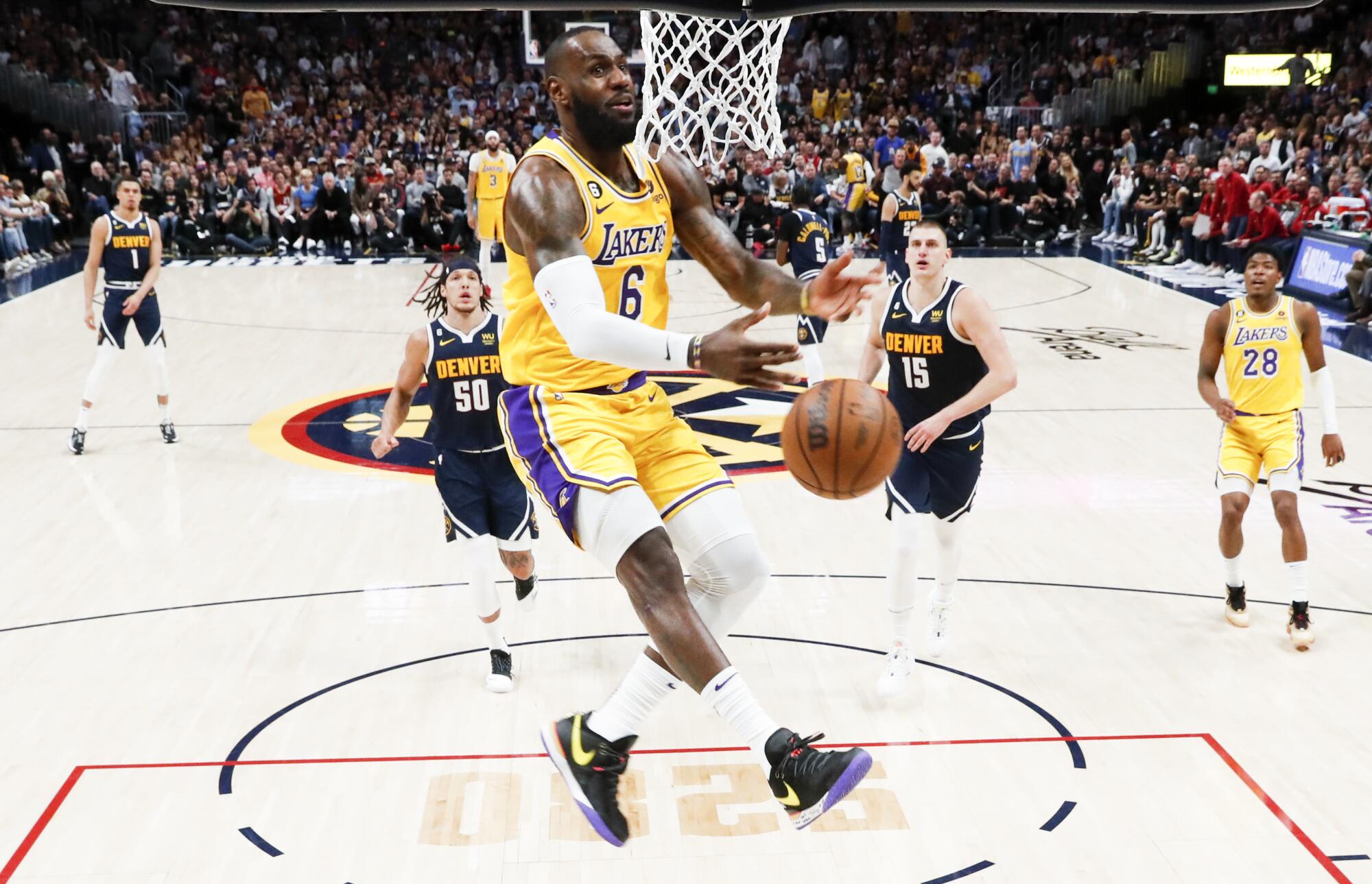 Lakers forward LeBron James loses the ball while going up for a slam dunk against the Denver Nuggets.