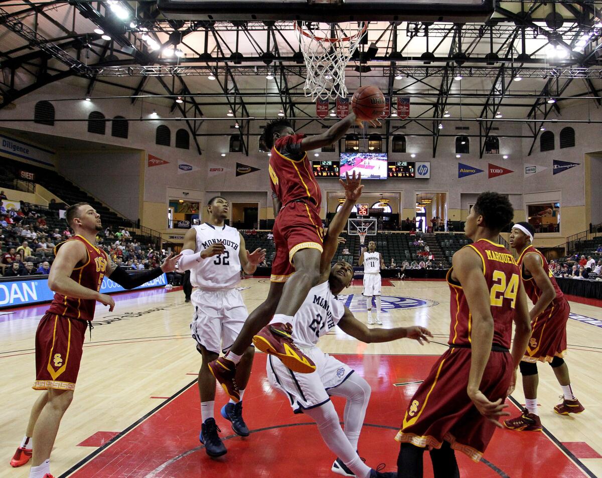 USC center Chimezie Metu blocks the shot of Monmouth's Austin Tilghman during a game in the AdvoCare Invitational.