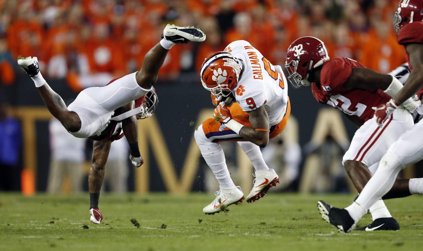 Clemson running back Wayne Gallman is brought down by Alabama defensive back Tony Brown (left) during a fourth-down run that came up short in the first quarter.