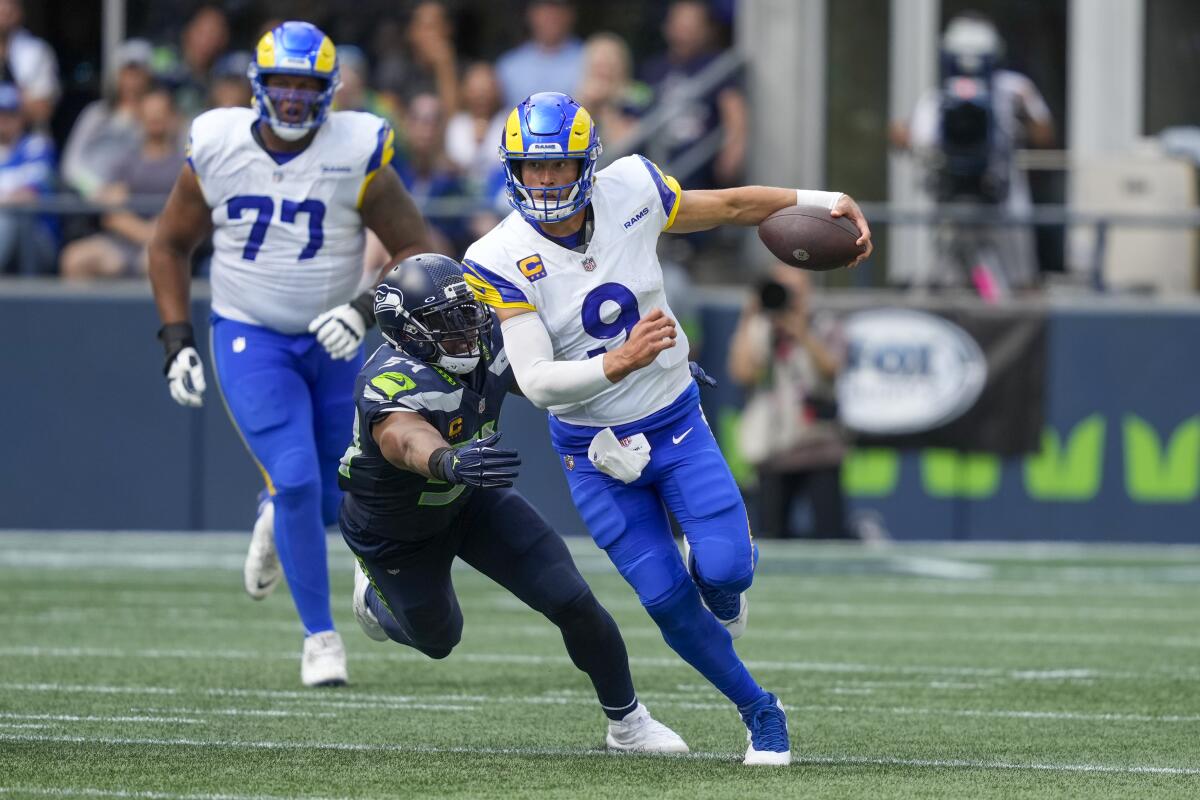 Rams quarterback Matthew Stafford tries to outrun the Seahawks' Bobby Wagner in their season opener.