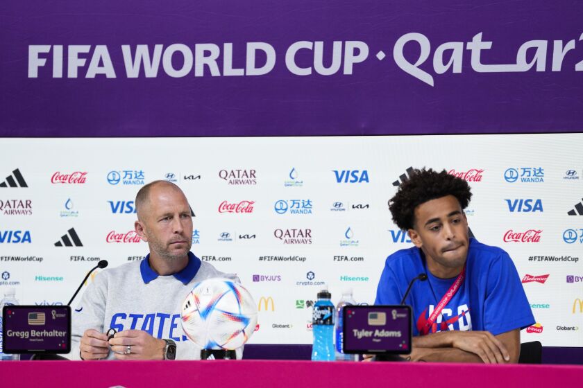 head coach Gregg Berhalter of the United States and Tyler Adams attend a press conference on the eve of the group B World Cup soccer match between Iran and the United States in Doha, Qatar, Monday, Nov. 28, 2022. (AP Photo/Ashley Landis)