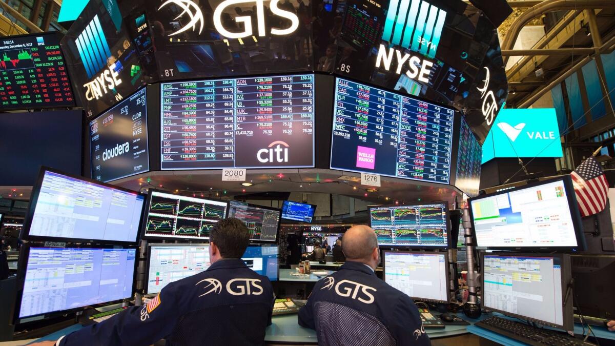 Nearly two stocks rose for every one that fell on the New York Stock Exchange, and the price of crude oil clawed back some of its sharp loss from Wednesday. Above, traders work on the floor of the New York Stock Exchange.