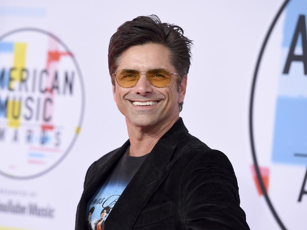 FILE - John Stamos appears at the American Music Awards in Los Angeles on Oct. 9, 2018. Publisher Henry Holt announced Wednesday that Stamos’ memoir “If You Would Have Told Me” is scheduled for fall 2023. (Photo by Jordan Strauss/Invision/AP, File)