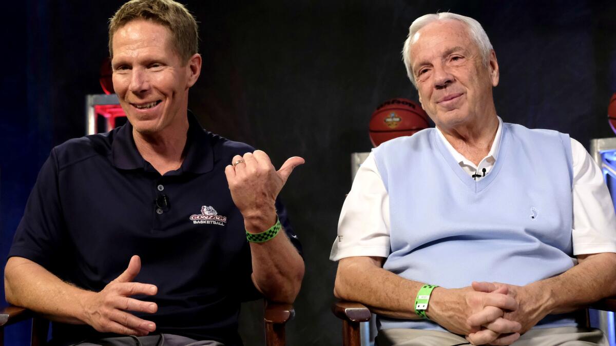 Coaches Mark Few, left, of Gonzaga and Roy Williams of North Carolina swap stories during an interview with CBS Sports Network on Sunday.