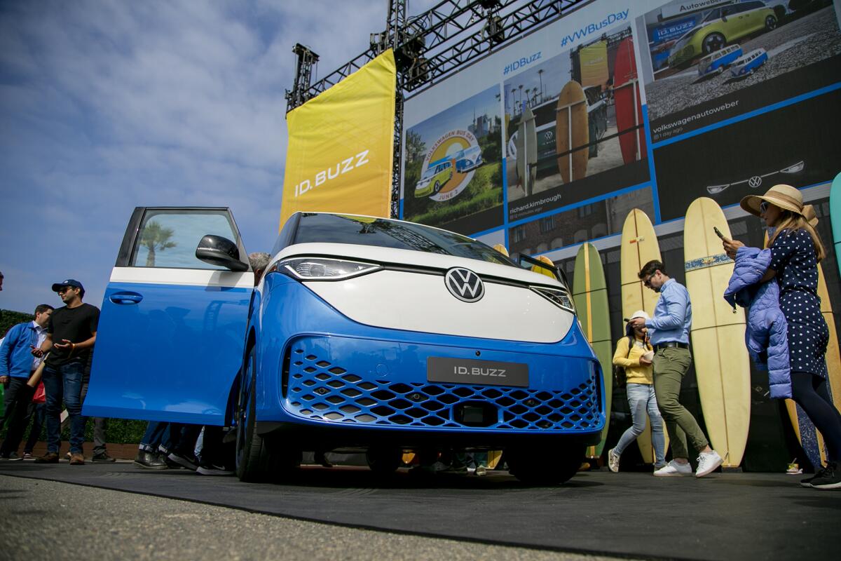 People take photos of the Volkswagen ID.Buzz, the electrified next generation of the classic VW Bus, on Friday.