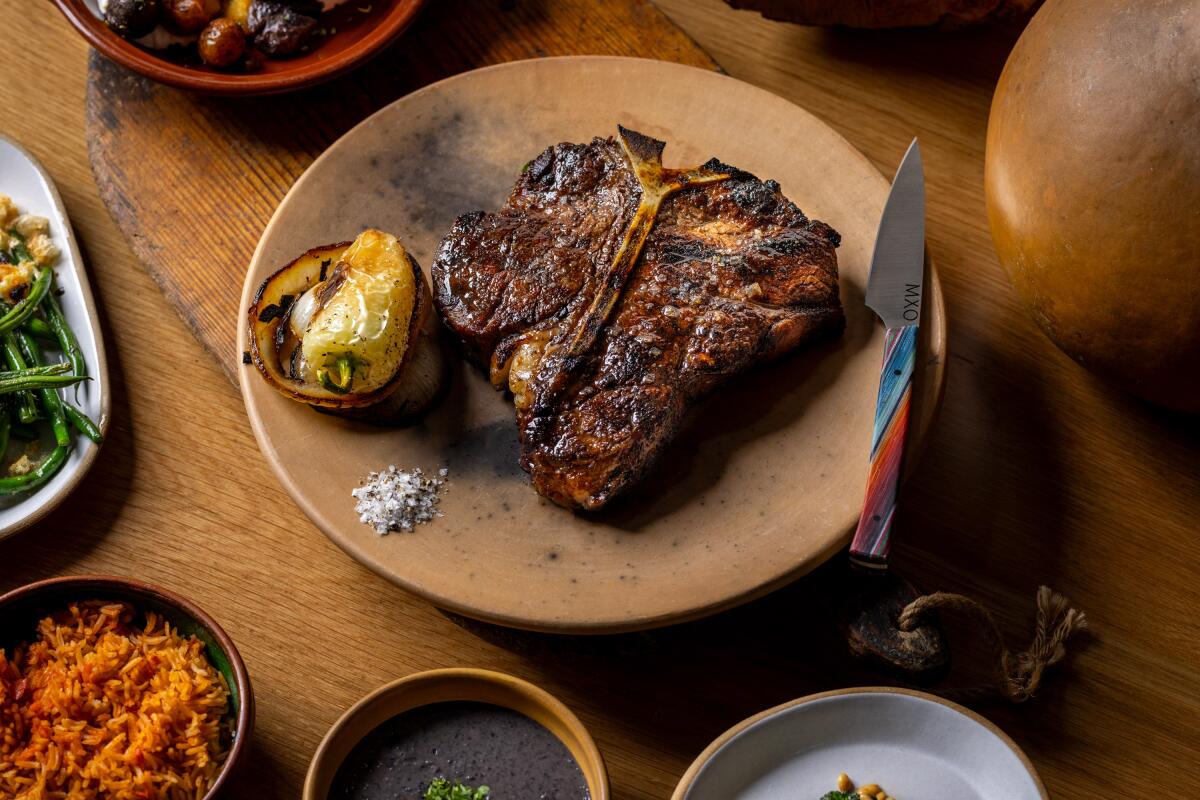 A whole bone-in steak with knife to the side at Wes Avila's Mexican steakhouse, MXO