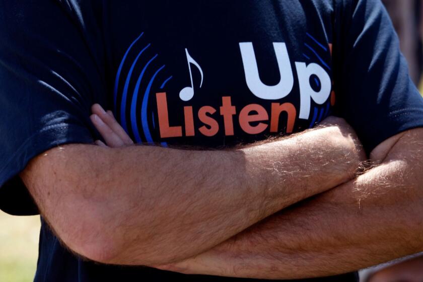 SANTA MONICA, CA - MAY 13, 2014 -- Musicians who work in the film and TV industry wore the t-shirt that stated, "Listen Up," during a rally to protest the outsourcing of their jobs in Stewart Street Park in Santa Monica on May 13, 2014. (Genaro Molina/Los Angeles Times)